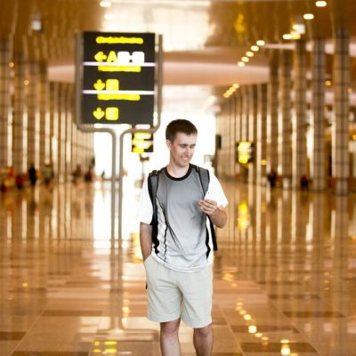 man-using-cell-phone-airport_1163-3487