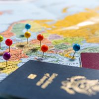 Maps with pins and passports, planning the holidays.